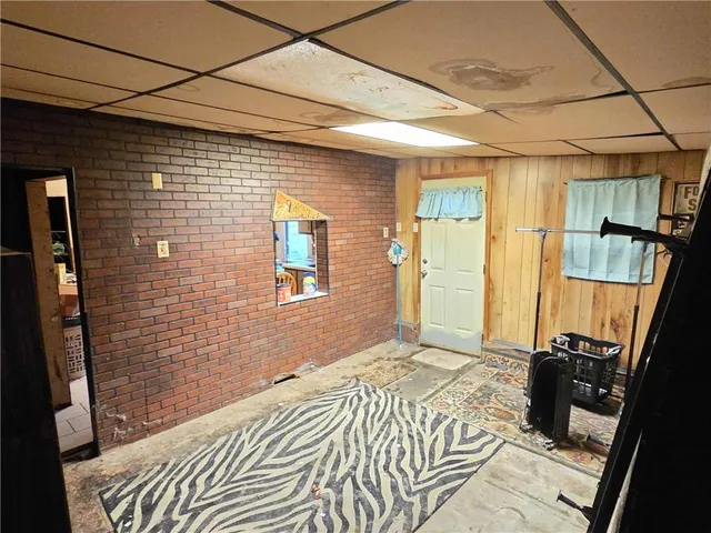 a bedroom with a bed and a flat tv screen