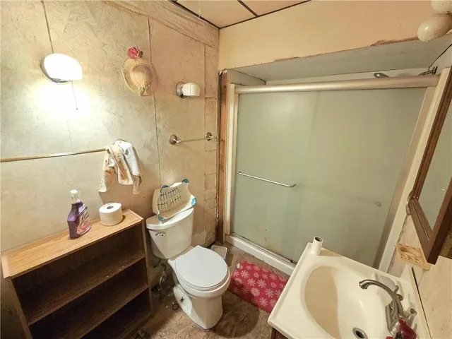 a bathroom with a sink mirror vanity and toilet
