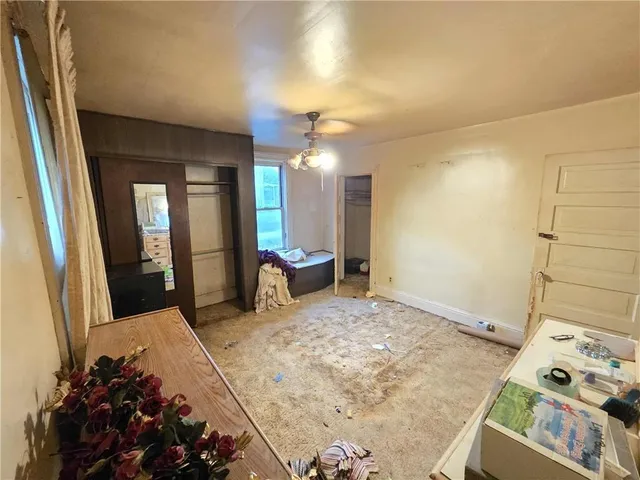 a bedroom with a bed and a mirror