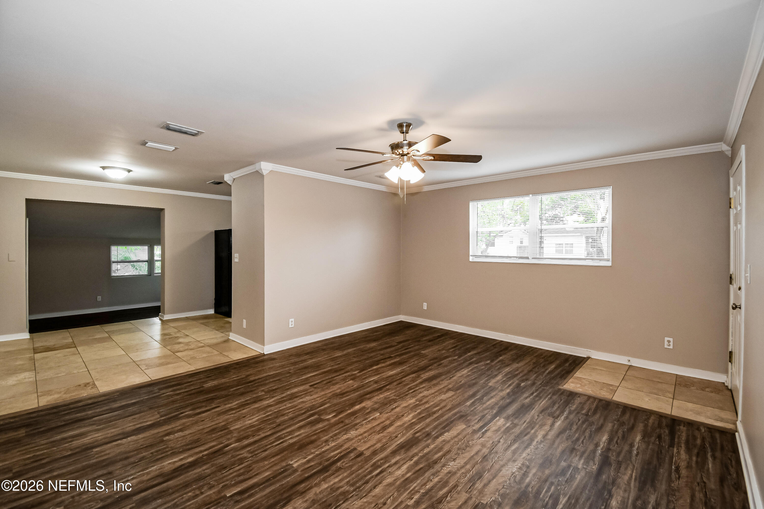 7227 Stonehurst Road North Jacksonville, FL 32277 - Photo 3 of 16 a view of an empty room with window and wooden floor