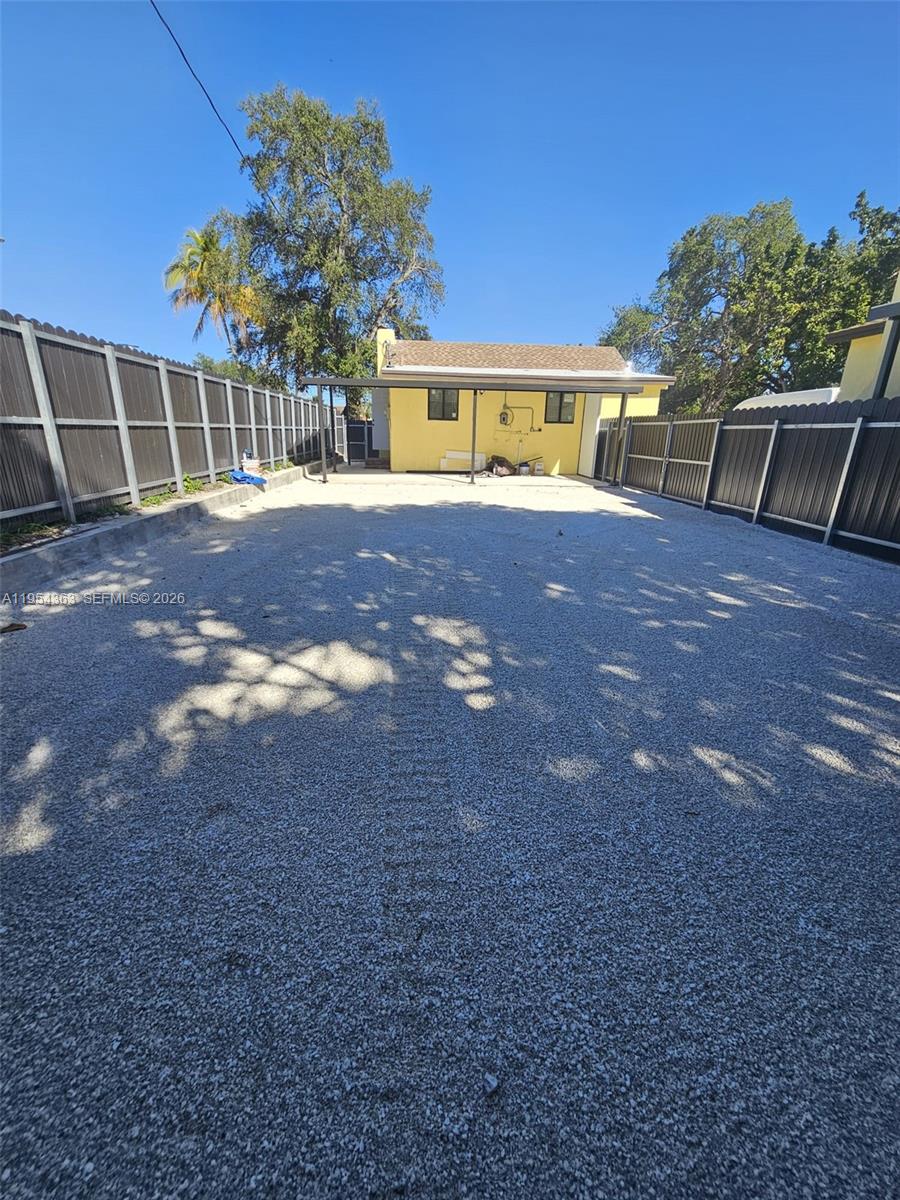 1148 Northwest 100th Street, Unit 1 Miami, FL 33150 - Photo 29 of 32 a backyard of a house with table and chairs