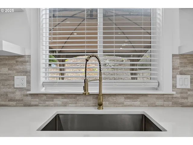a kitchen with a sink and a window