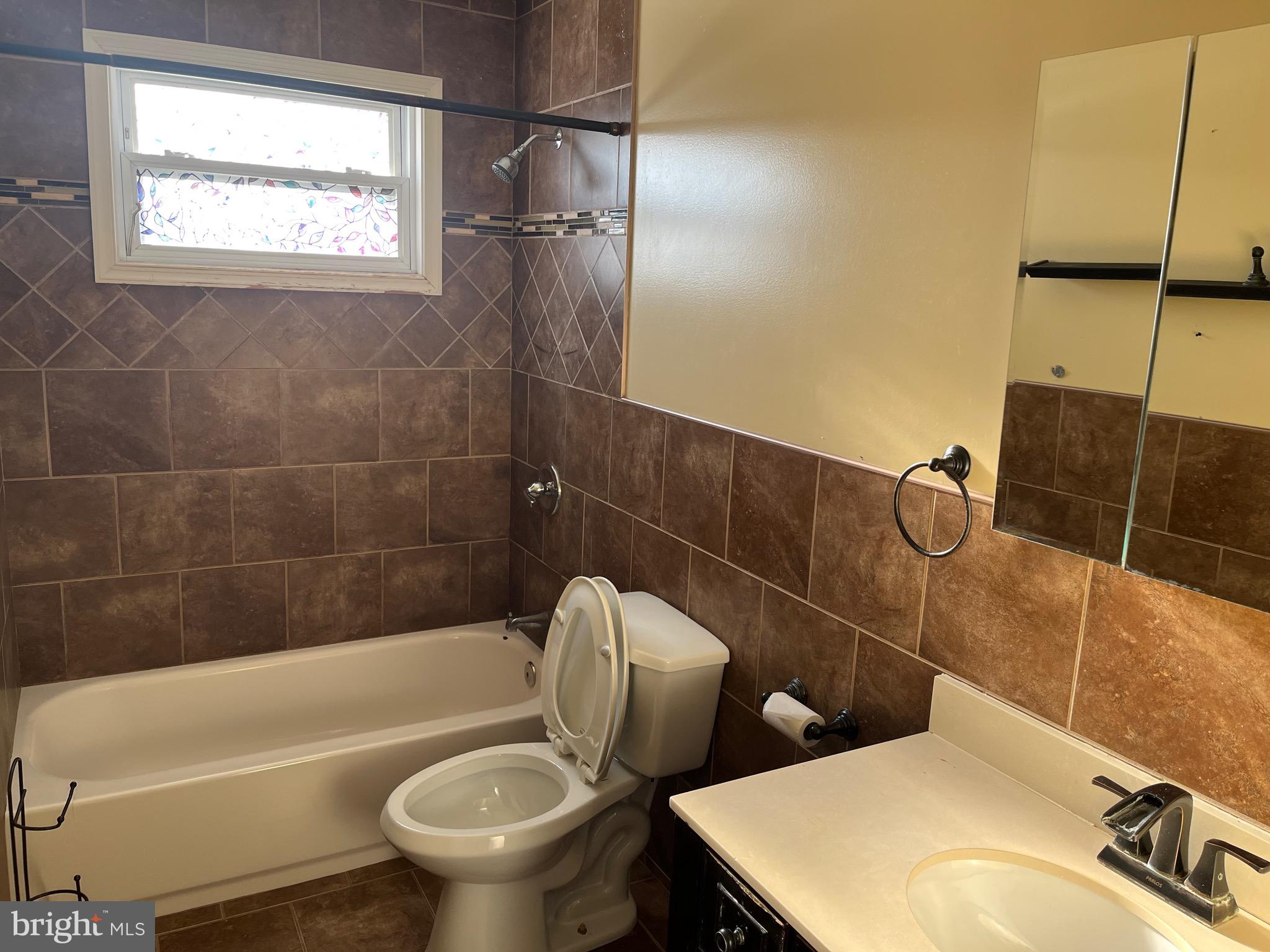 8829 Sigrid Road Randallstown, MD 21133 - Photo 11 of 23 a bathroom with a toilet a sink and bathtub