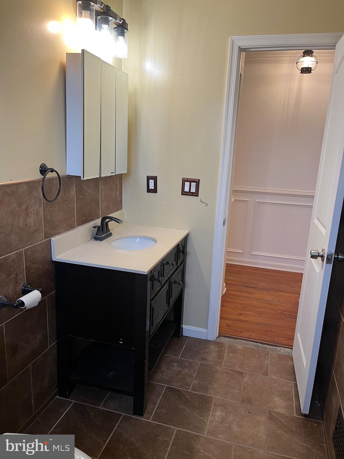 8829 Sigrid Road Randallstown, MD 21133 - Photo 14 of 28 a bathroom with a sink and a mirror