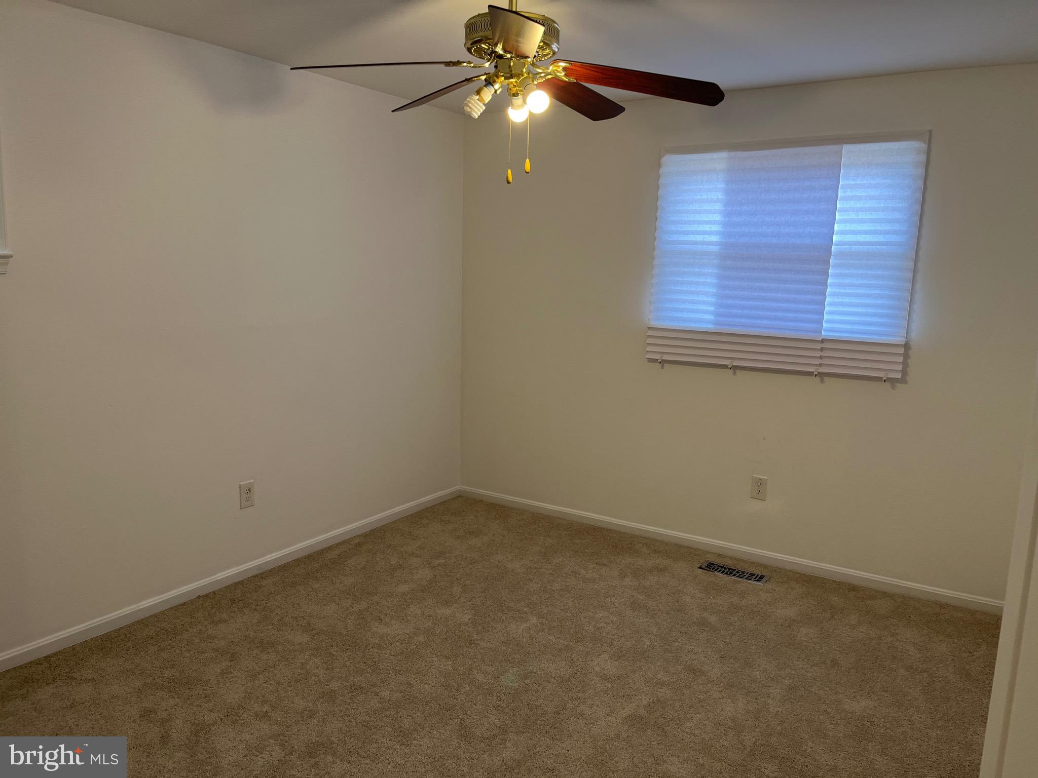 8829 Sigrid Road Randallstown, MD 21133 - Photo 16 of 28 an empty room with windows and fan