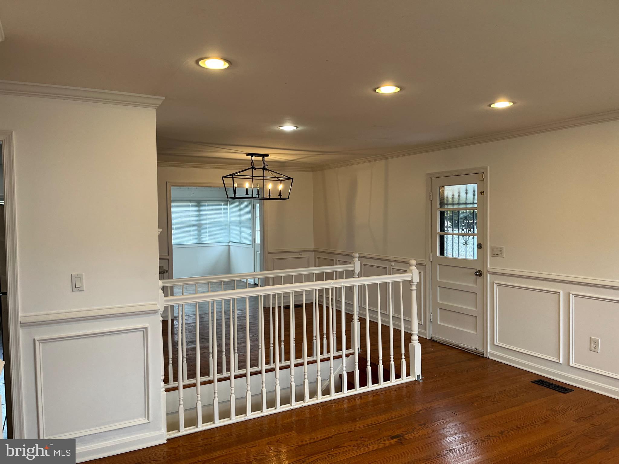 8829 Sigrid Road Randallstown, MD 21133 - Photo 2 of 28 a view of hallway with wooden floor and stairs