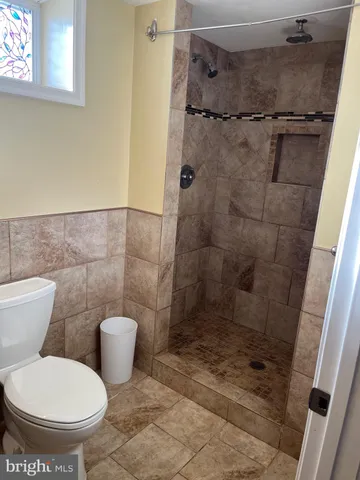 a bathroom with a toilet and a shower