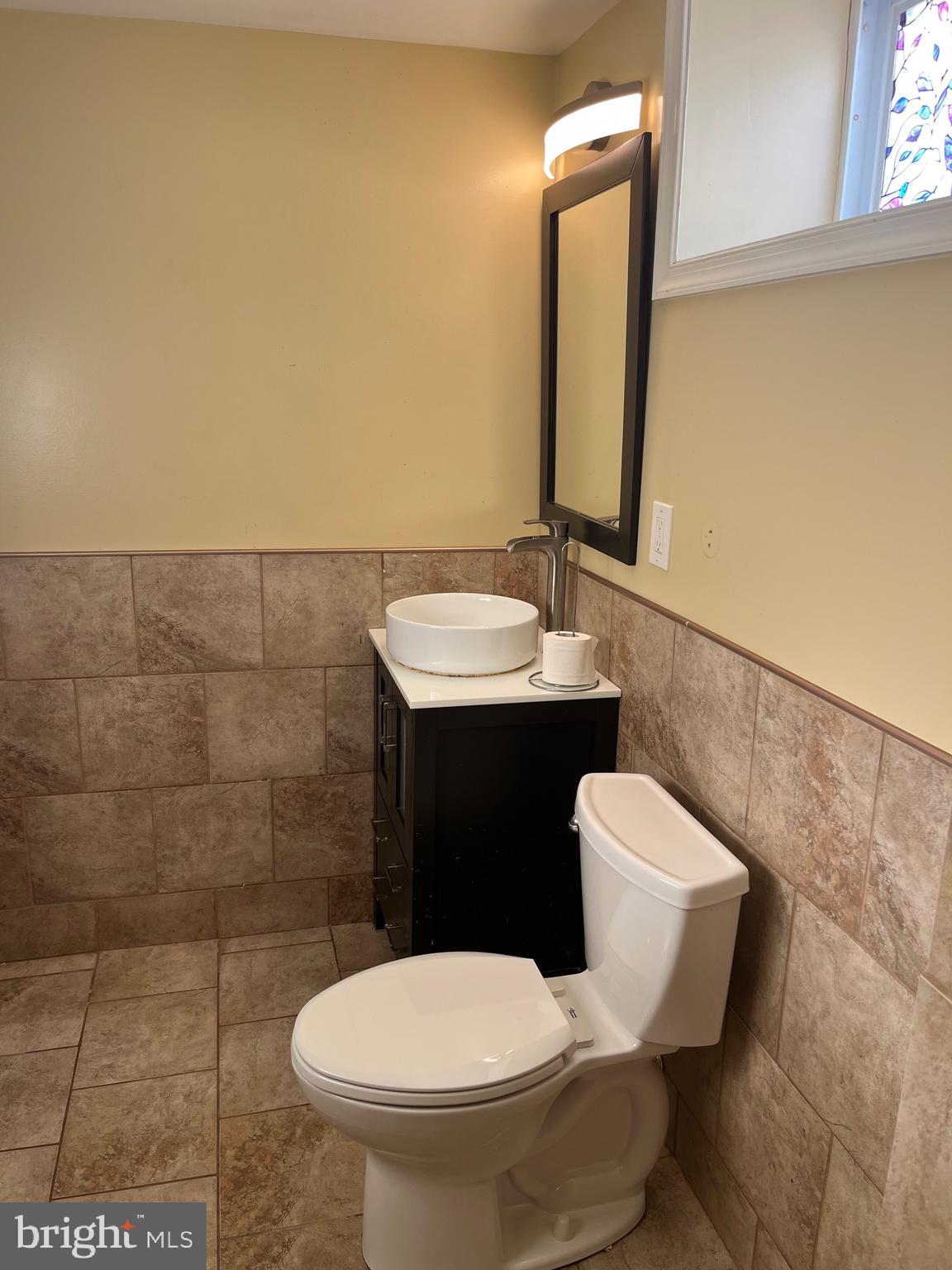 8829 Sigrid Road Randallstown, MD 21133 - Photo 23 of 23 a bathroom with a toilet sink and mirror