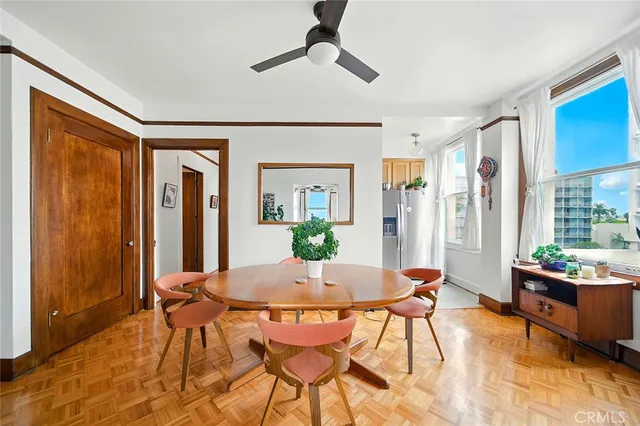 a view of a dining room with furniture and a potted plant