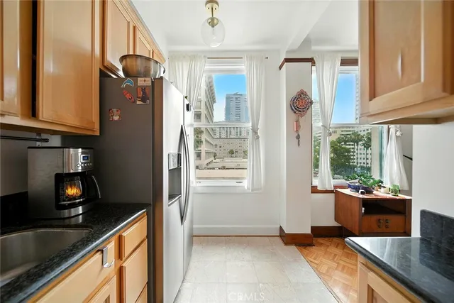a kitchen with granite countertop a sink a stove and cabinets