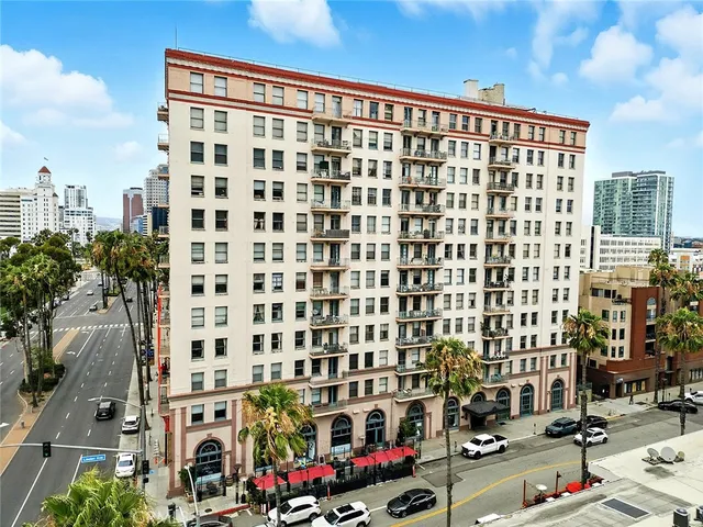 a living room with furniture a fireplace and a floor to ceiling window