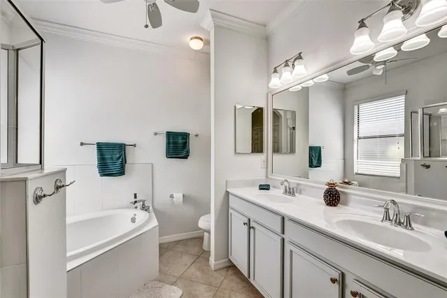 a bathroom with a tub a sink and mirror