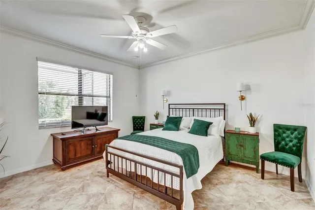 a bedroom with a bed and a chandelier