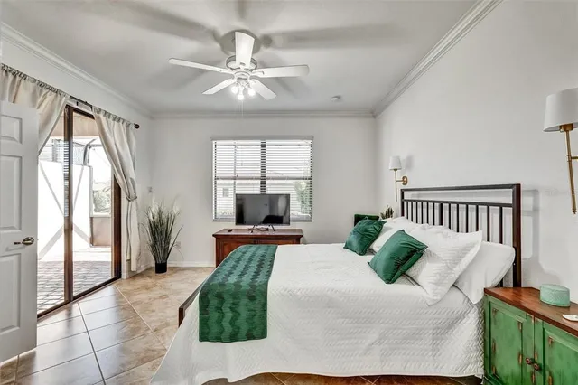 a bedroom with a large bed and a chandelier