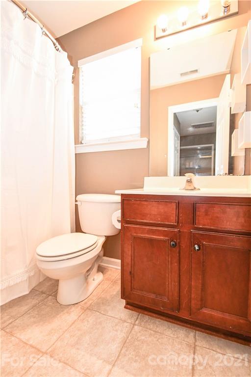 1903 Travertine Lane Fort Mill, SC 29708 - Photo 20 of 20 a bathroom with a toilet a sink and a mirror