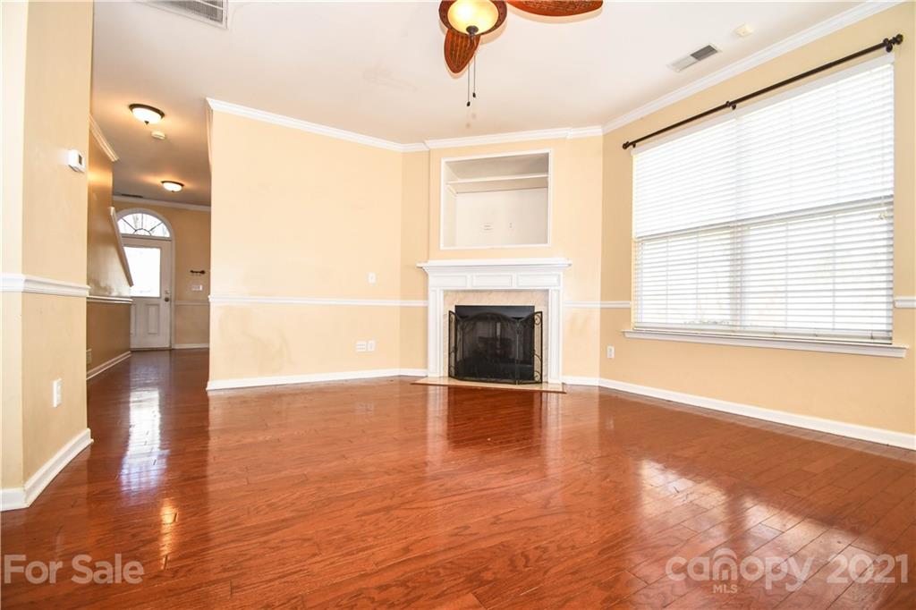 1903 Travertine Lane Fort Mill, SC 29708 - Photo 3 of 20 a view of an empty room with glass door and wooden floor