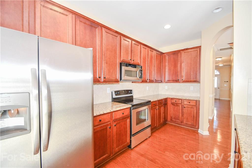 1903 Travertine Lane Fort Mill, SC 29708 - Photo 8 of 20 a kitchen with stainless steel appliances granite countertop a refrigerator a stove top oven a sink and dishwasher