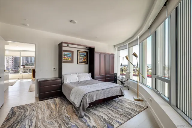 a view of a patio with couches table and chairs and potted plants