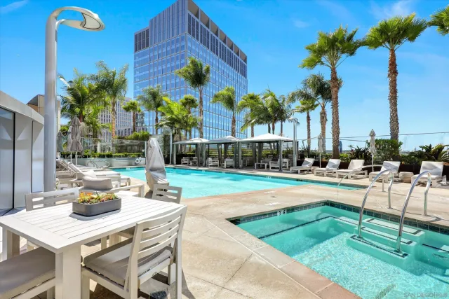a bathroom with a granite countertop sink a mirror and a bathtub