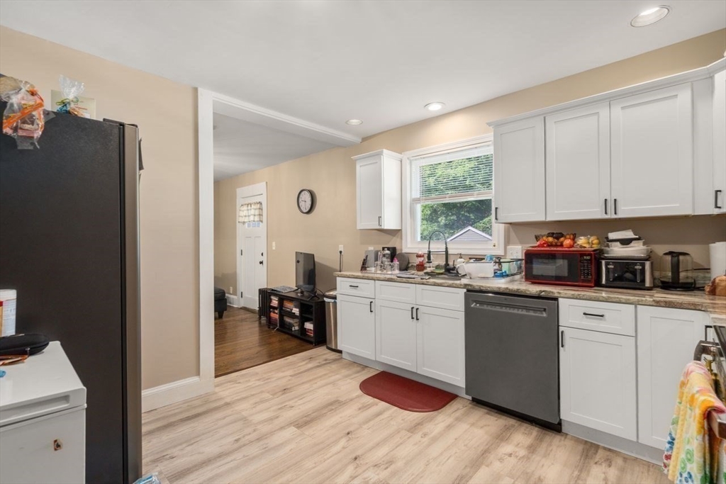 38 Manchester Terrace Springfield, MA 01108 - Photo 8 of 15 a kitchen with stainless steel appliances granite countertop a refrigerator a sink dishwasher a stove and white countertops with wooden floor