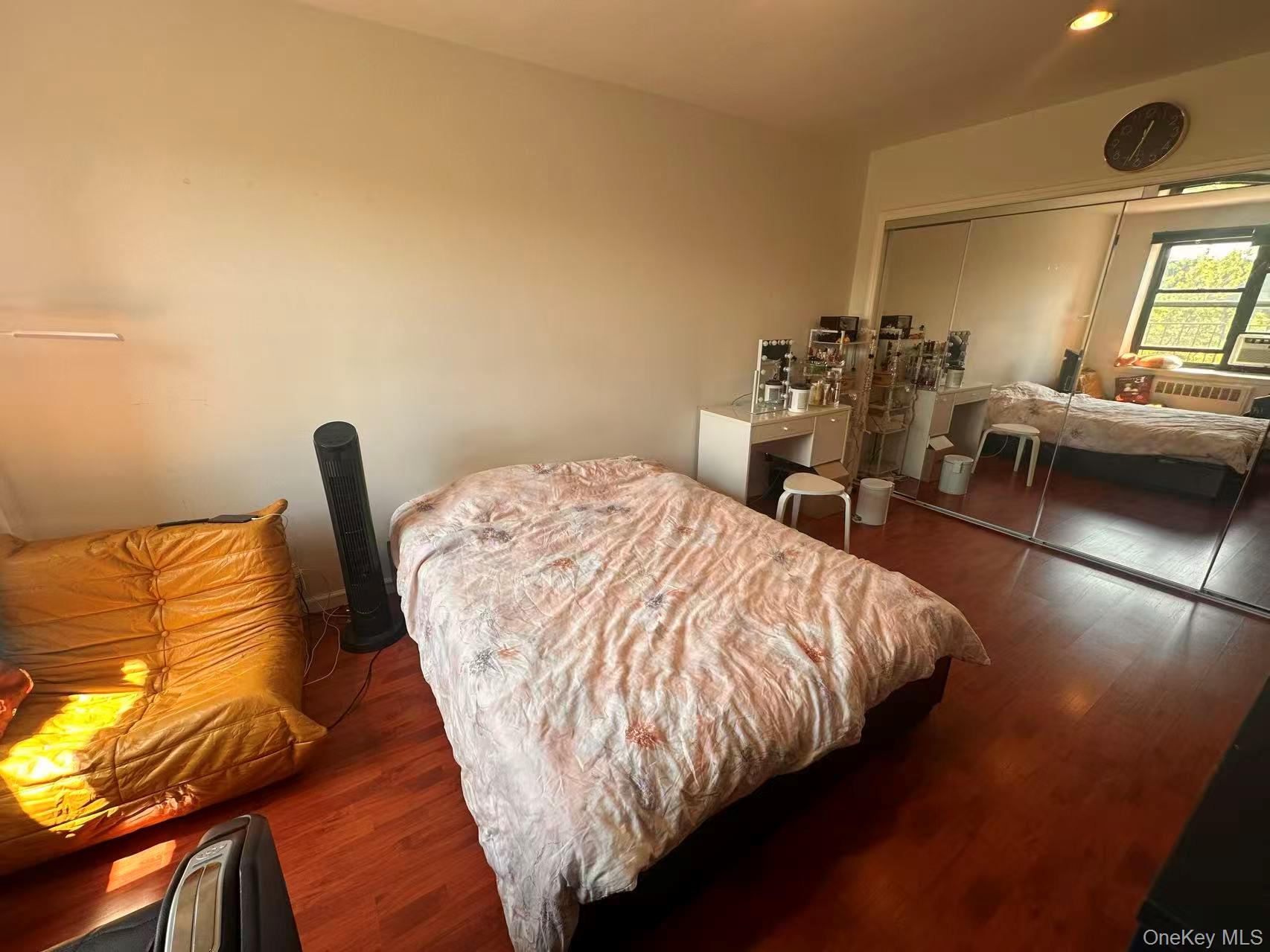 139-15 28th Road, Unit 6G Queens, NY 11354 - Photo 15 of 20 a bed sitting in a bedroom next to a window