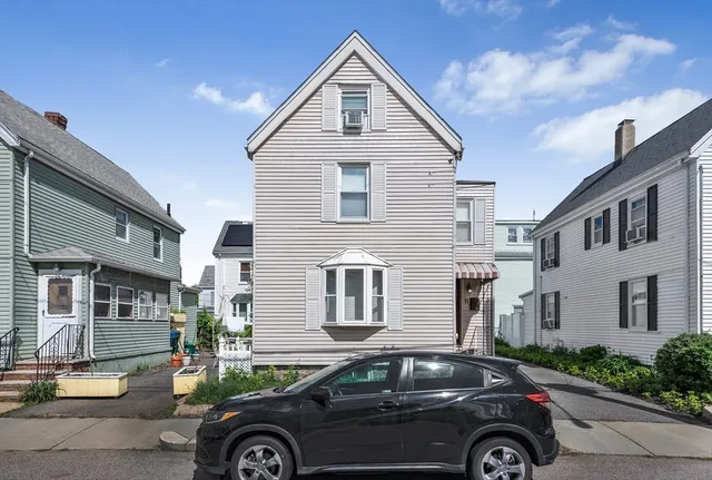 a front view of a house with parking space