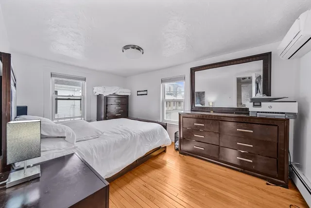 a bedroom with a bed and a dresser