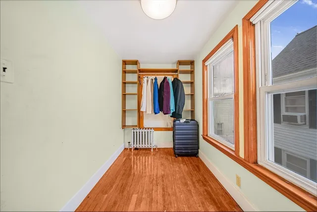 a view of hallway with wooden floor and stairs