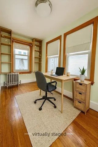 a workspace with furniture window and wooden floor