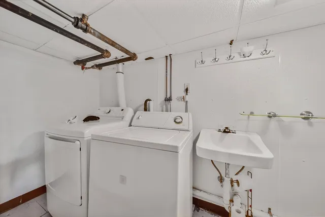 a view of a house with a patio and a yard