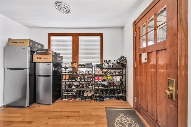 a view of kitchen with refrigerator and wooden floor