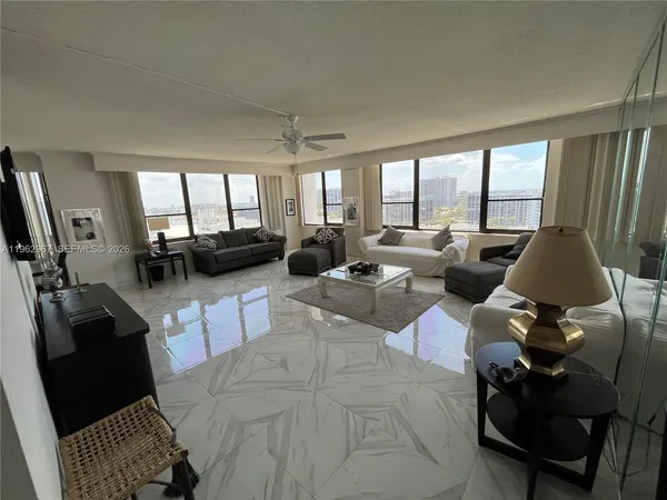 a living room with furniture large window and flat screen tv