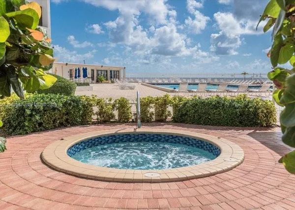 a view of a swimming pool with a yard