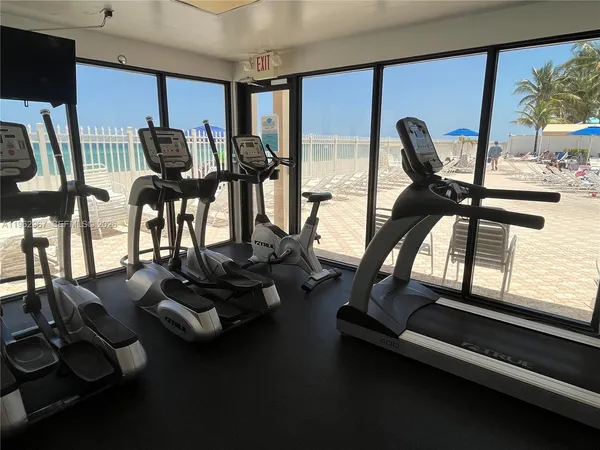 a dining room with furniture and floor to ceiling window