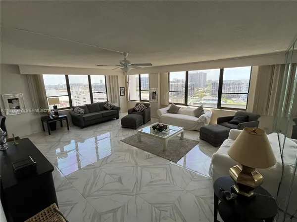 a living room with furniture and large windows