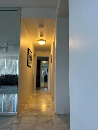 a view of a hallway with wooden shelves