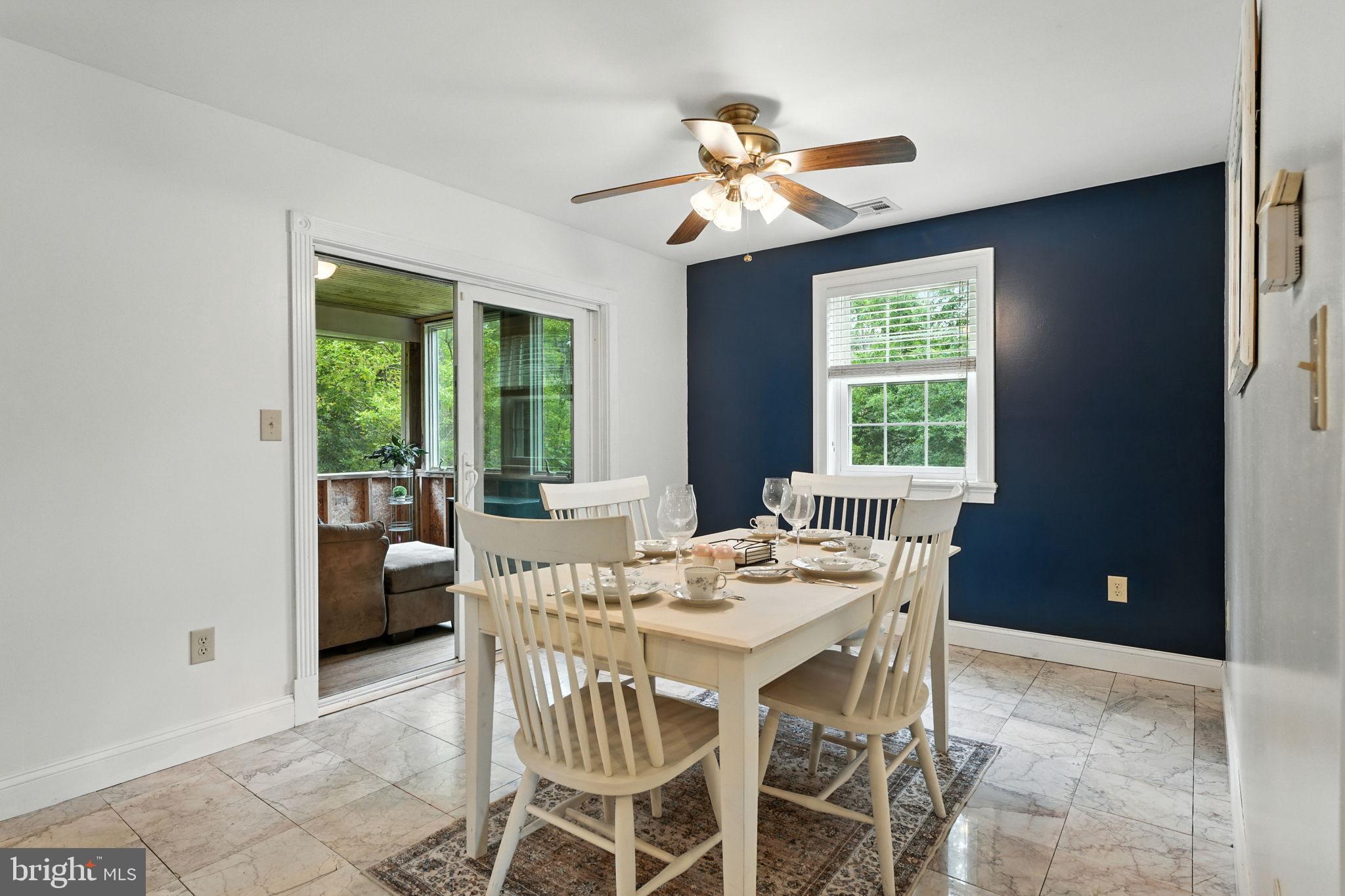 609 Creek Road Kennett Square, PA 19348 - Photo 11 of 39 a view of a dining room with furniture wooden floor and chandelier