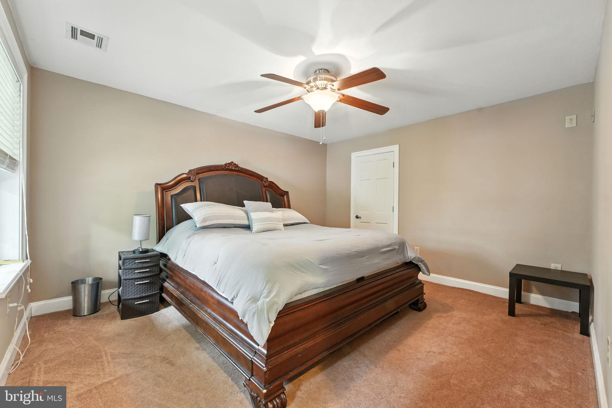 609 Creek Road Kennett Square, PA 19348 - Photo 14 of 39 a bedroom with a bed and a chandelier