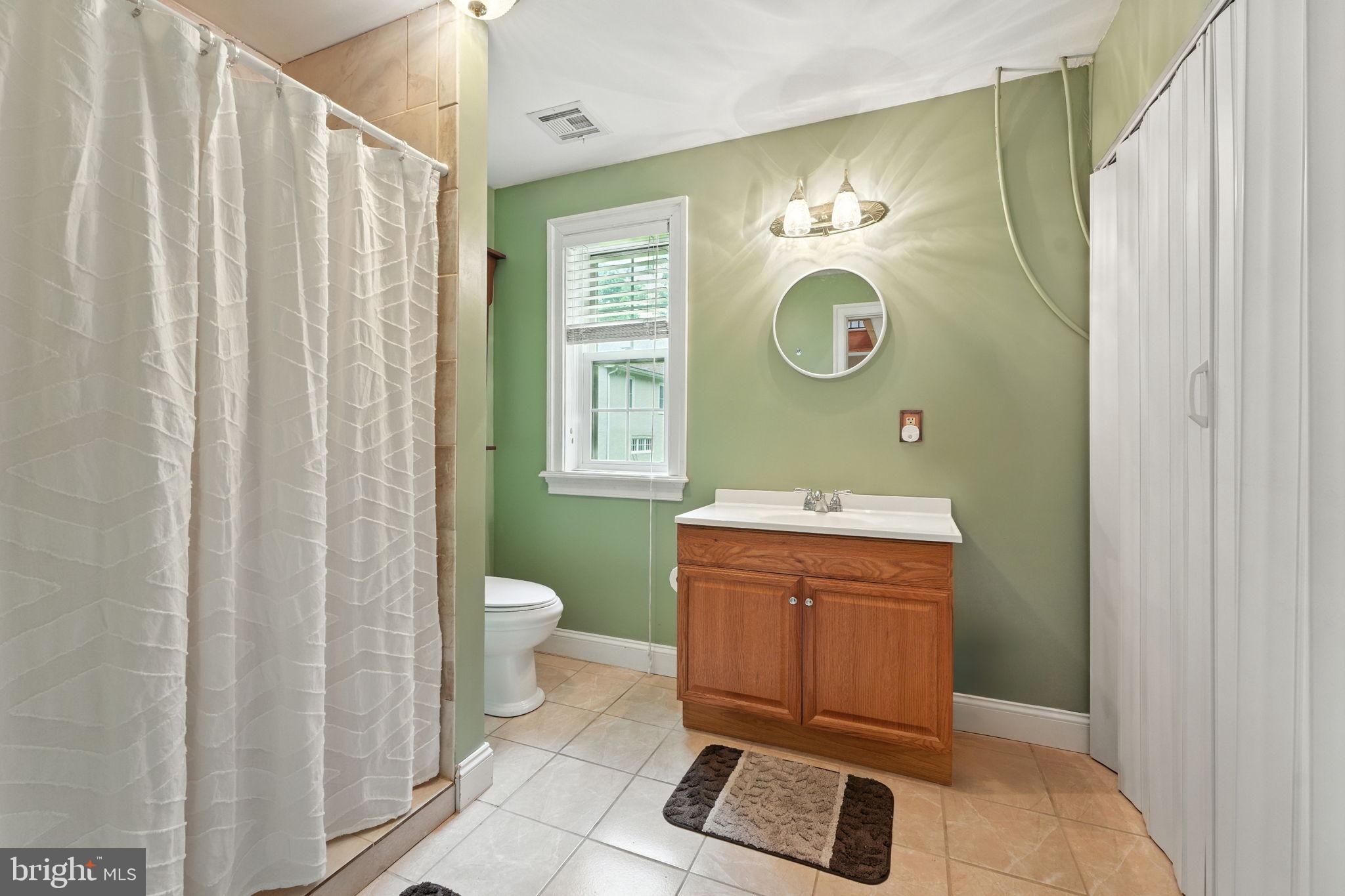 609 Creek Road Kennett Square, PA 19348 - Photo 15 of 39 a bathroom with a sink mirror and toilet