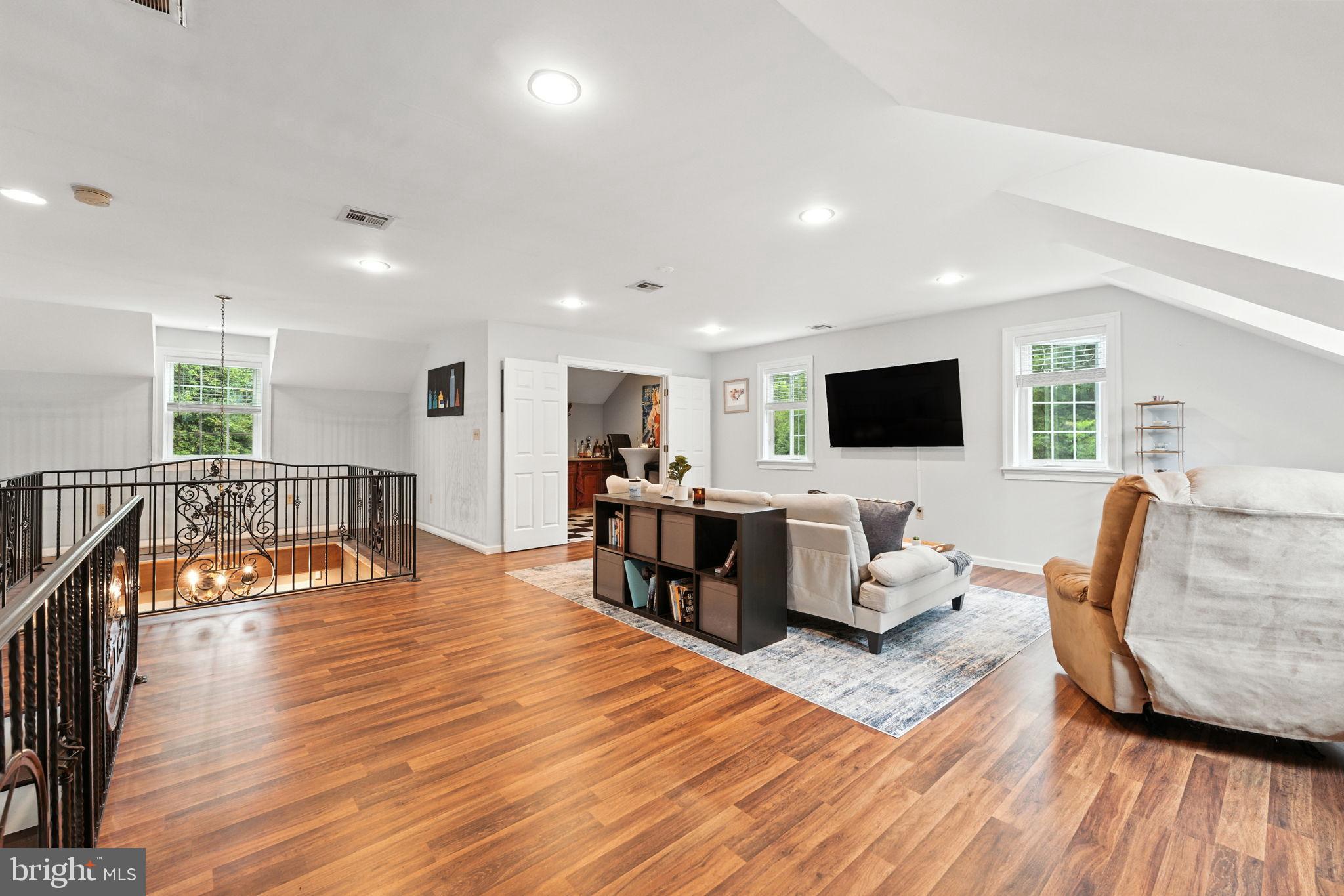 609 Creek Road Kennett Square, PA 19348 - Photo 18 of 39 a living room with furniture wooden floor and a flat screen tv