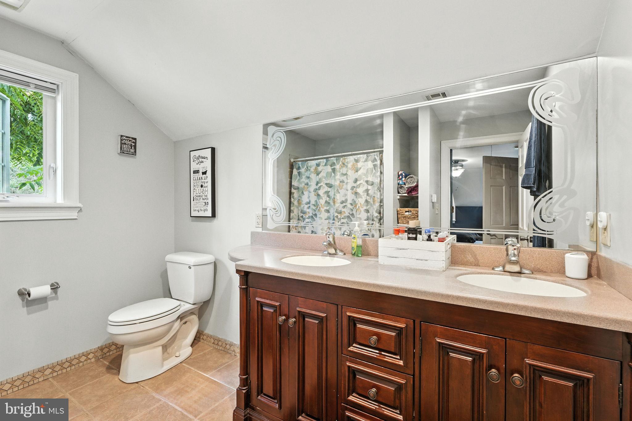 609 Creek Road Kennett Square, PA 19348 - Photo 27 of 39 a bathroom with a double vanity sink toilet and a mirror