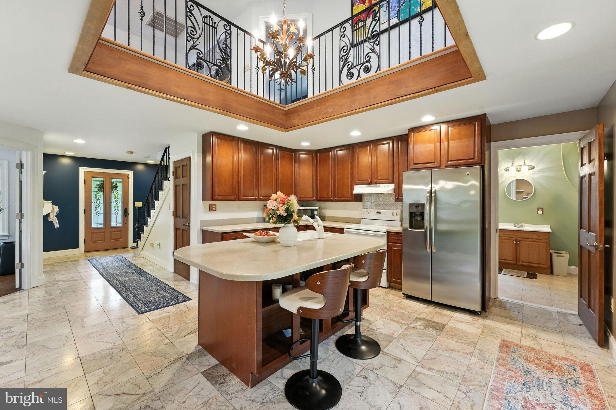 609 Creek Road Kennett Square, PA 19348 - Photo 3 of 39 a kitchen with refrigerator and chairs