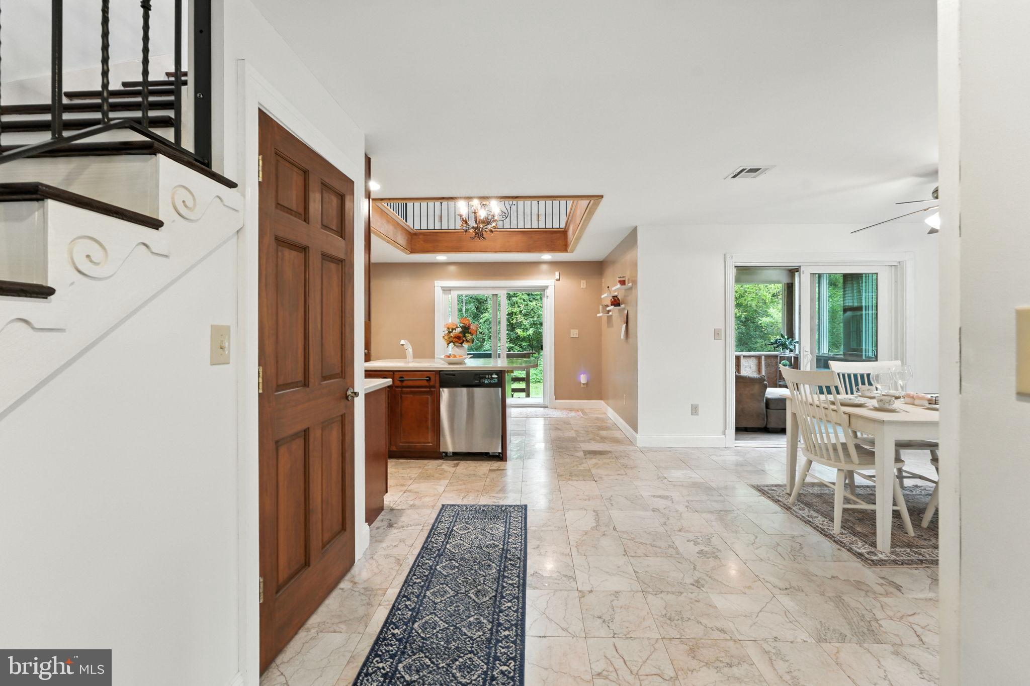 609 Creek Road Kennett Square, PA 19348 - Photo 4 of 39 a living room with furniture a large window with kitchen view
