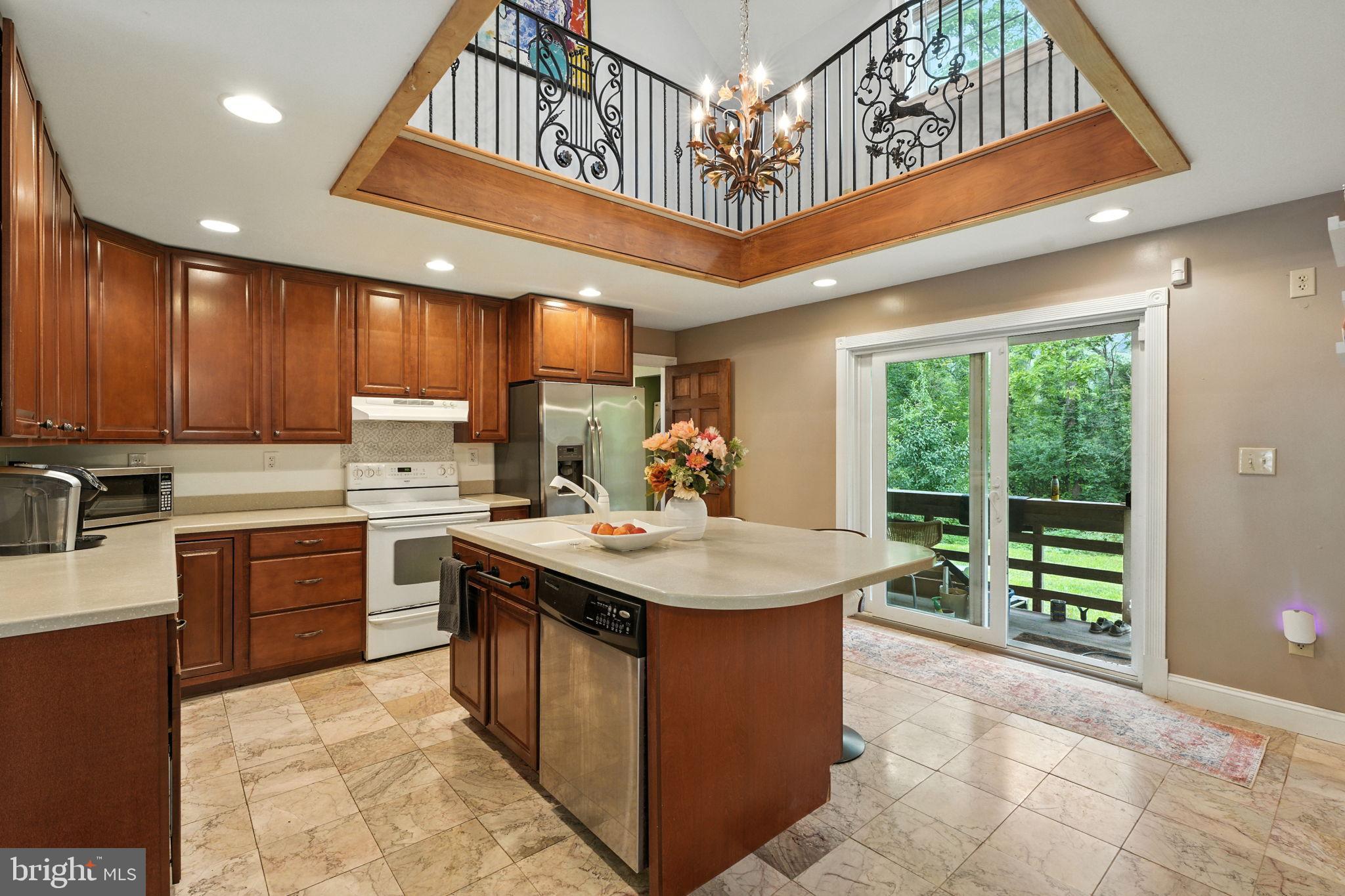 609 Creek Road Kennett Square, PA 19348 - Photo 5 of 39 a kitchen with kitchen island granite countertop a sink counter top space appliances and cabinets