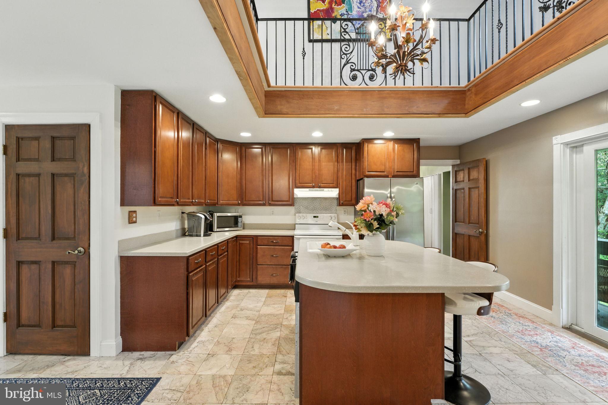 609 Creek Road Kennett Square, PA 19348 - Photo 6 of 39 a kitchen with kitchen island a stove a center island cabinets and furniture