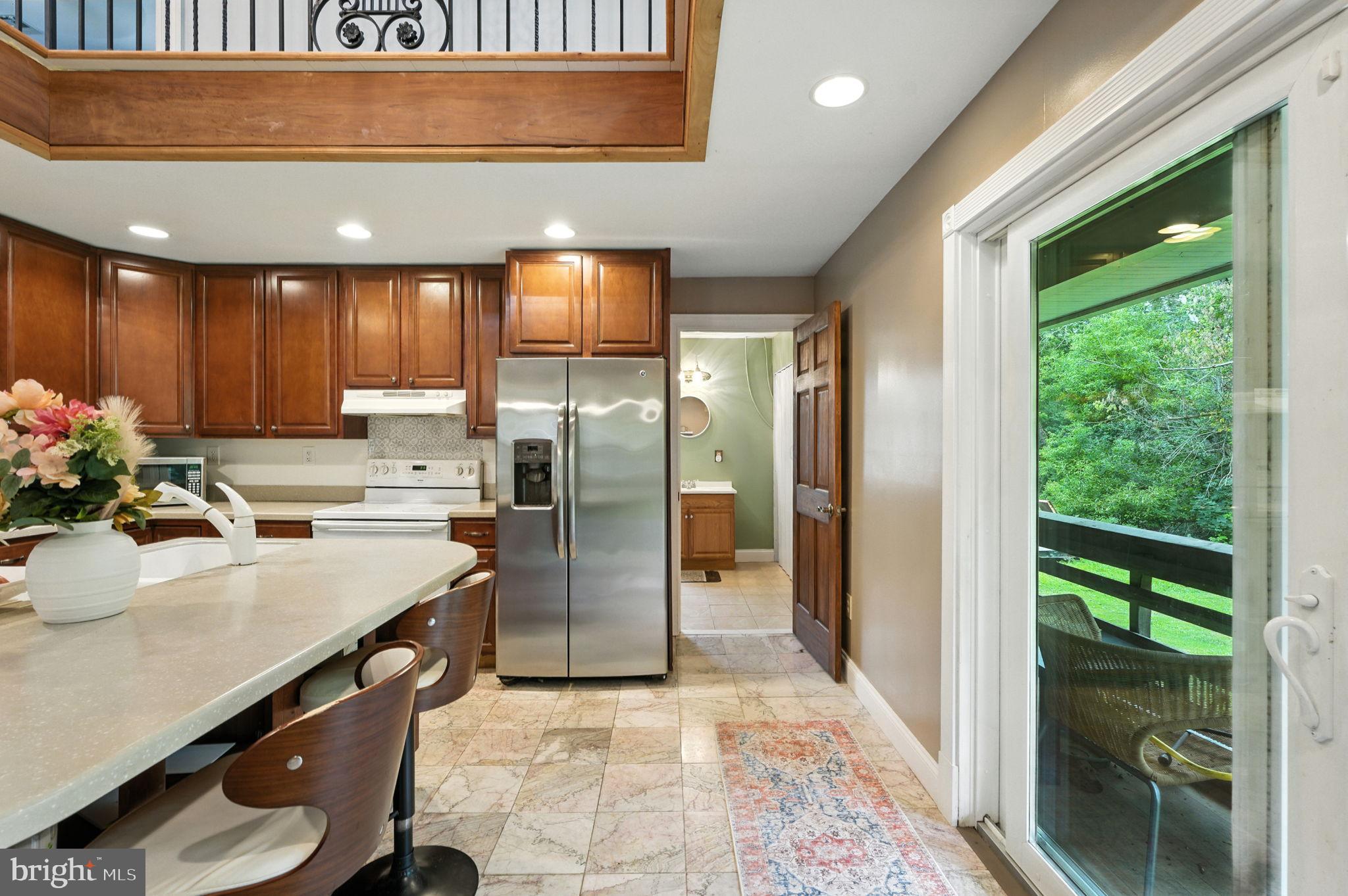 609 Creek Road Kennett Square, PA 19348 - Photo 8 of 39 a kitchen with kitchen island a counter top a sink stainless steel appliances and cabinets