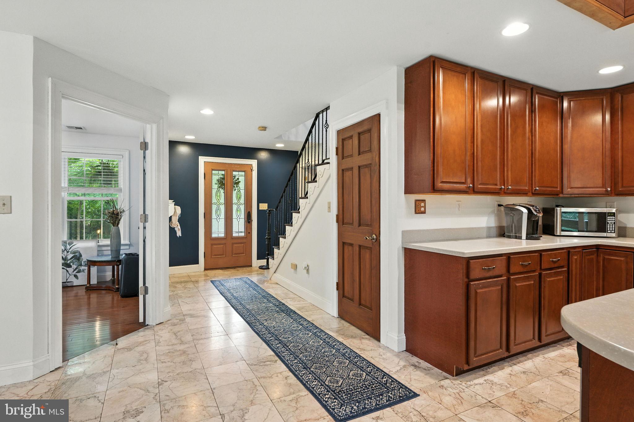 609 Creek Road Kennett Square, PA 19348 - Photo 10 of 39 a large white kitchen with stainless steel appliances granite countertop a refrigerator and cabinets