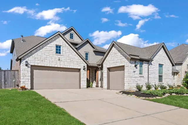 a view of residential house and garage