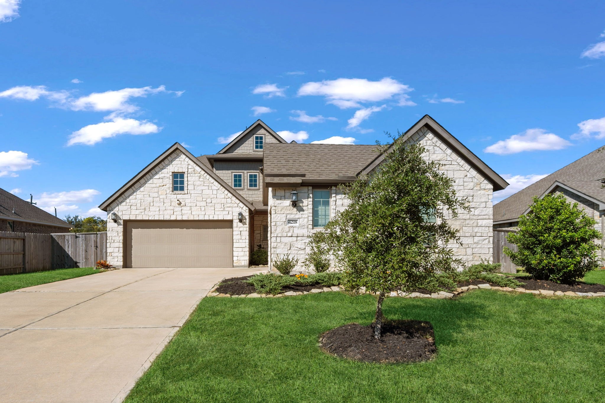 4218 Redford Valley Road Rosharon, TX 77583 - Photo 2 of 36 a front view of a house with a garden and plants