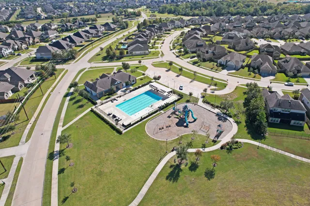 an aerial view of a house with a swimming pool
